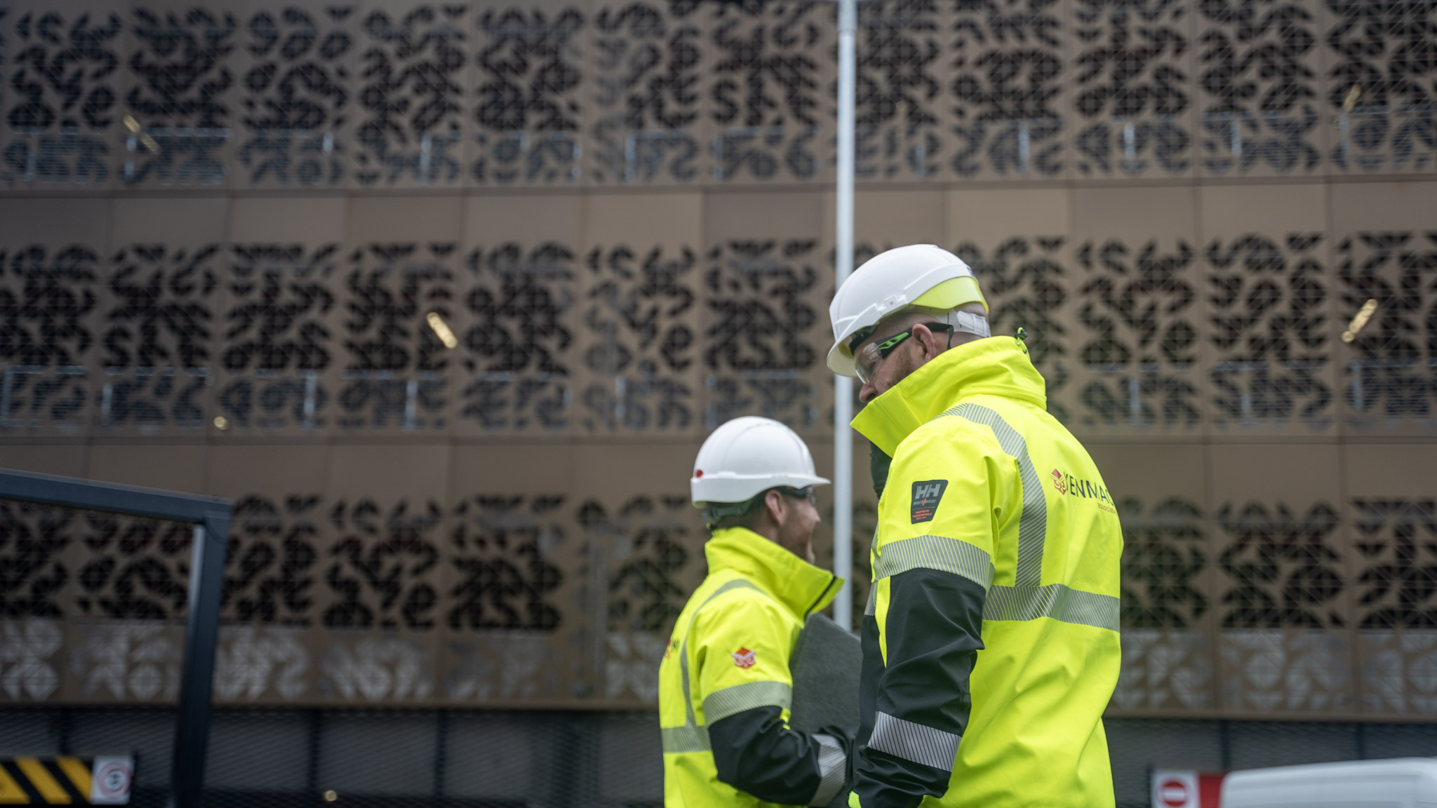 Kenmac consultants in high-visibility jackets on a site visit