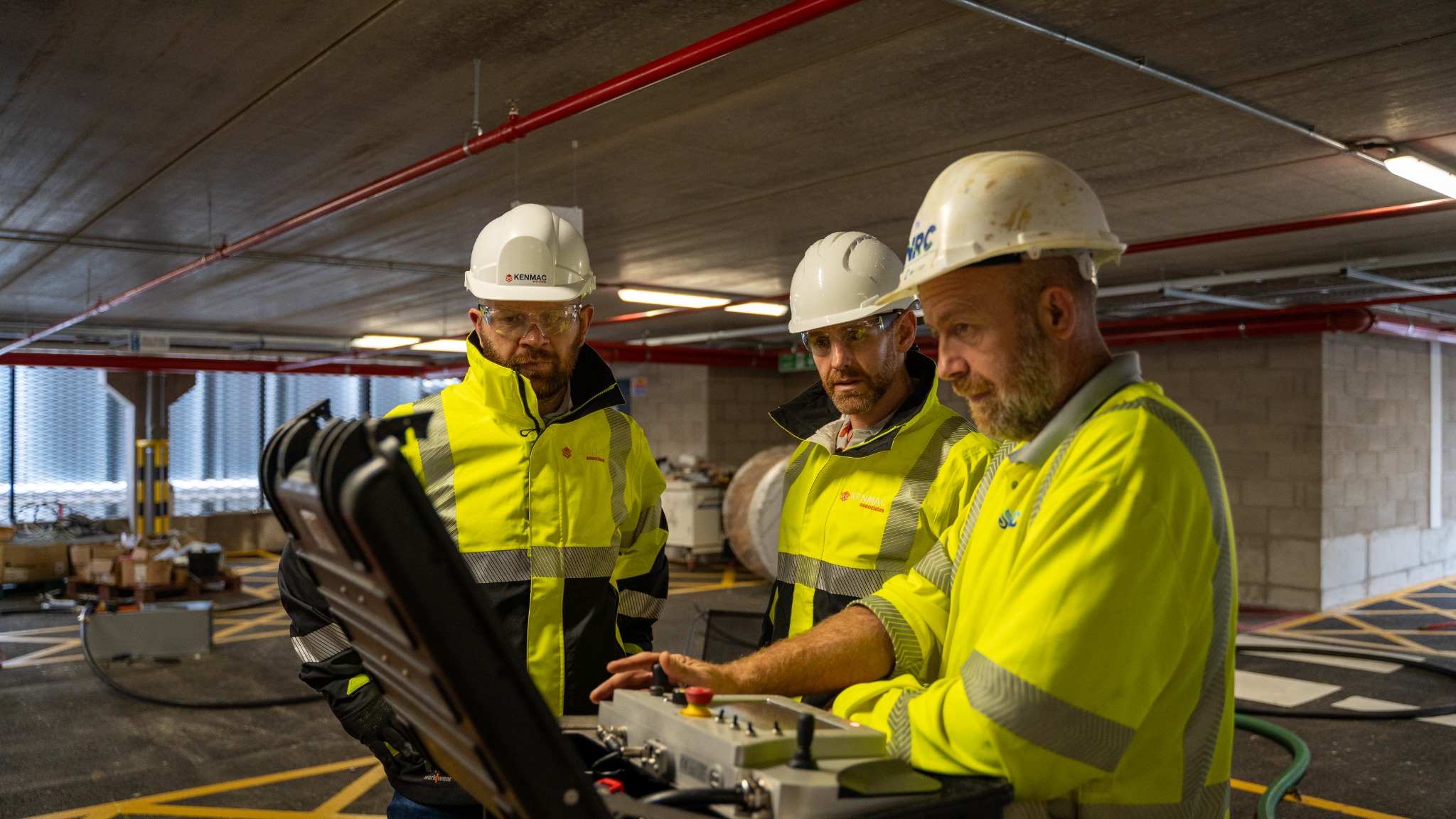 Kenmac consultants reviewing equipment and site operations with a contractor